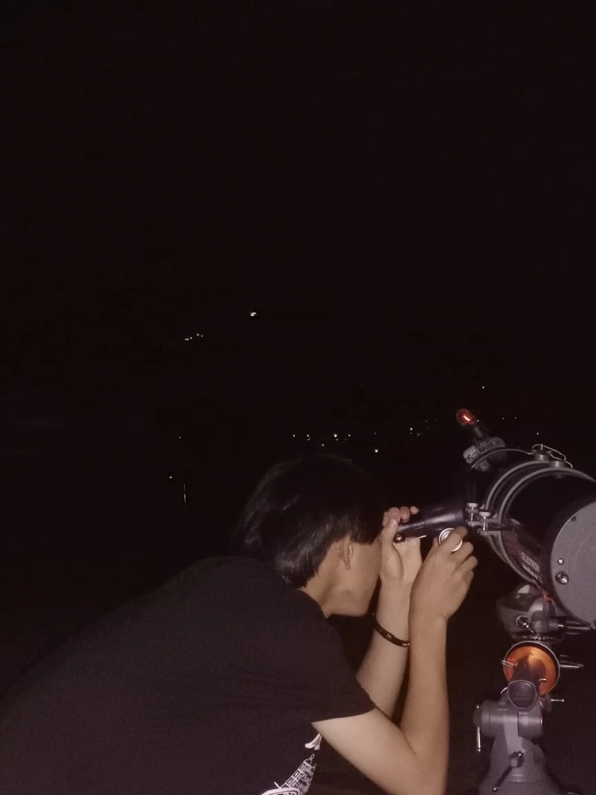 Night sky observation with telescope under clear dark skies