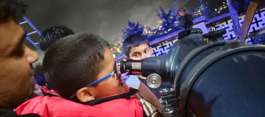 Telescope pointed at the Milky Way during a stargazing event