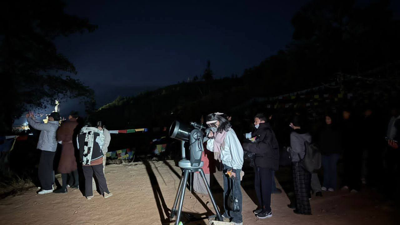 Preparing telescope equipment at dusk