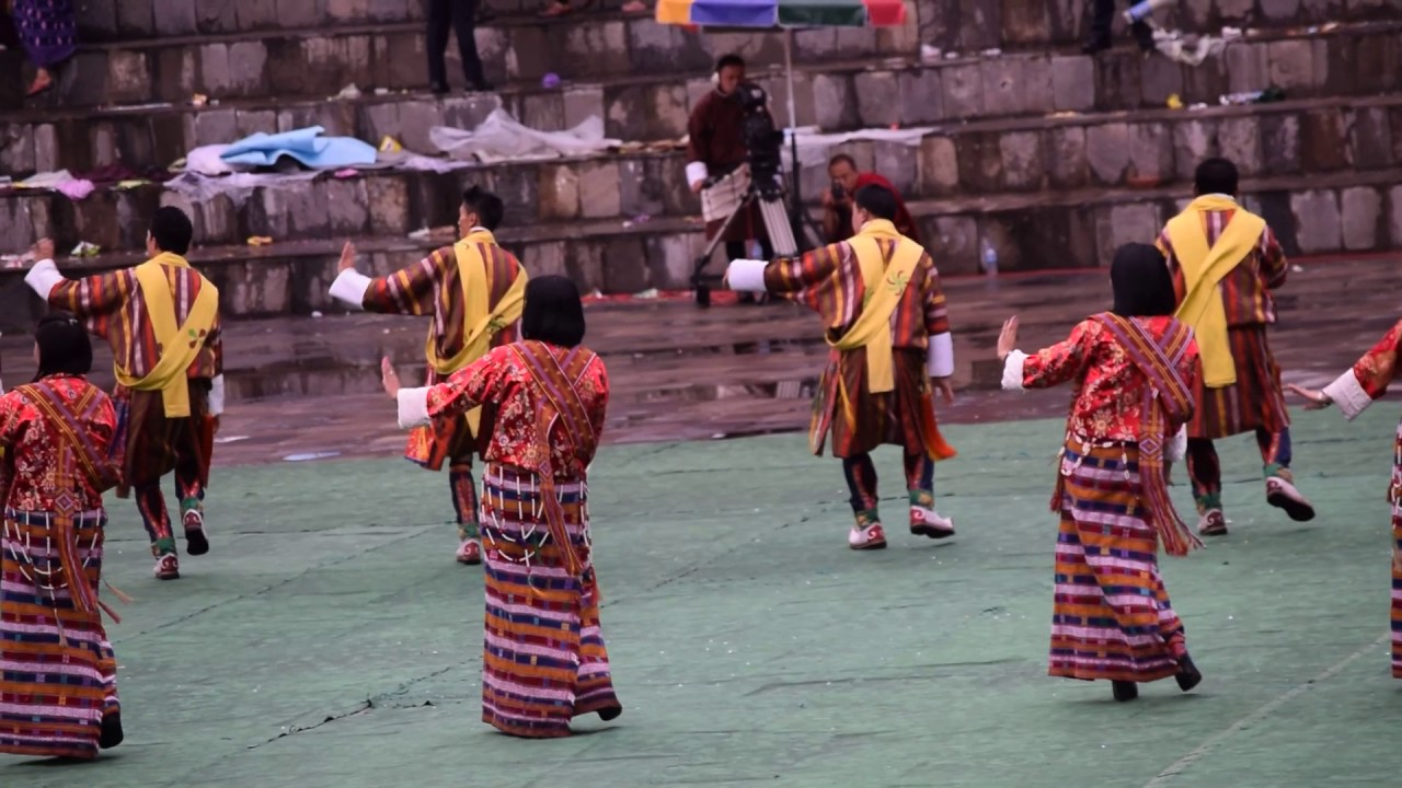 Colorful Bhutanese festival dancers in traditional attire