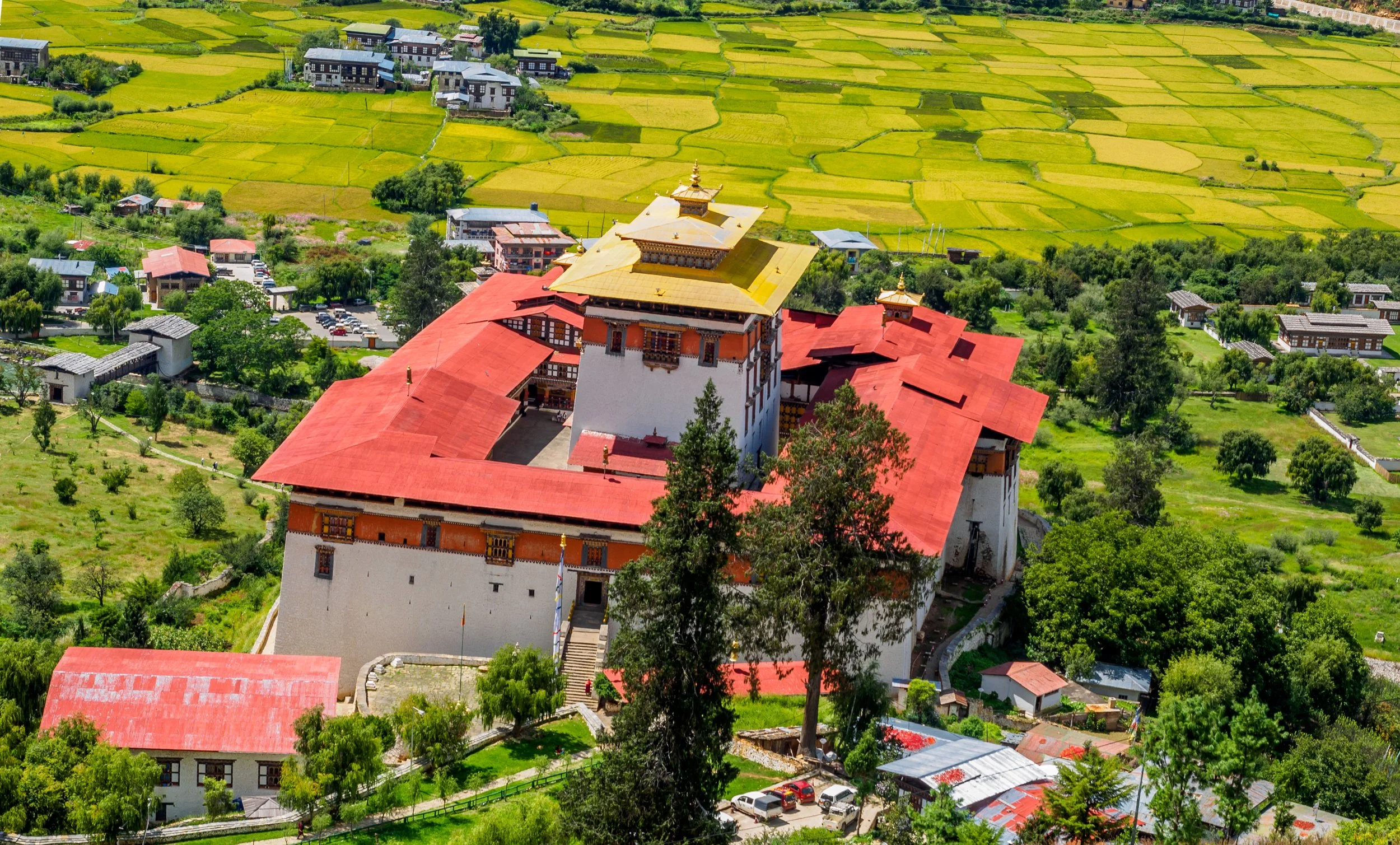 Hikers traversing a scenic mountain trail in the Paro Valley